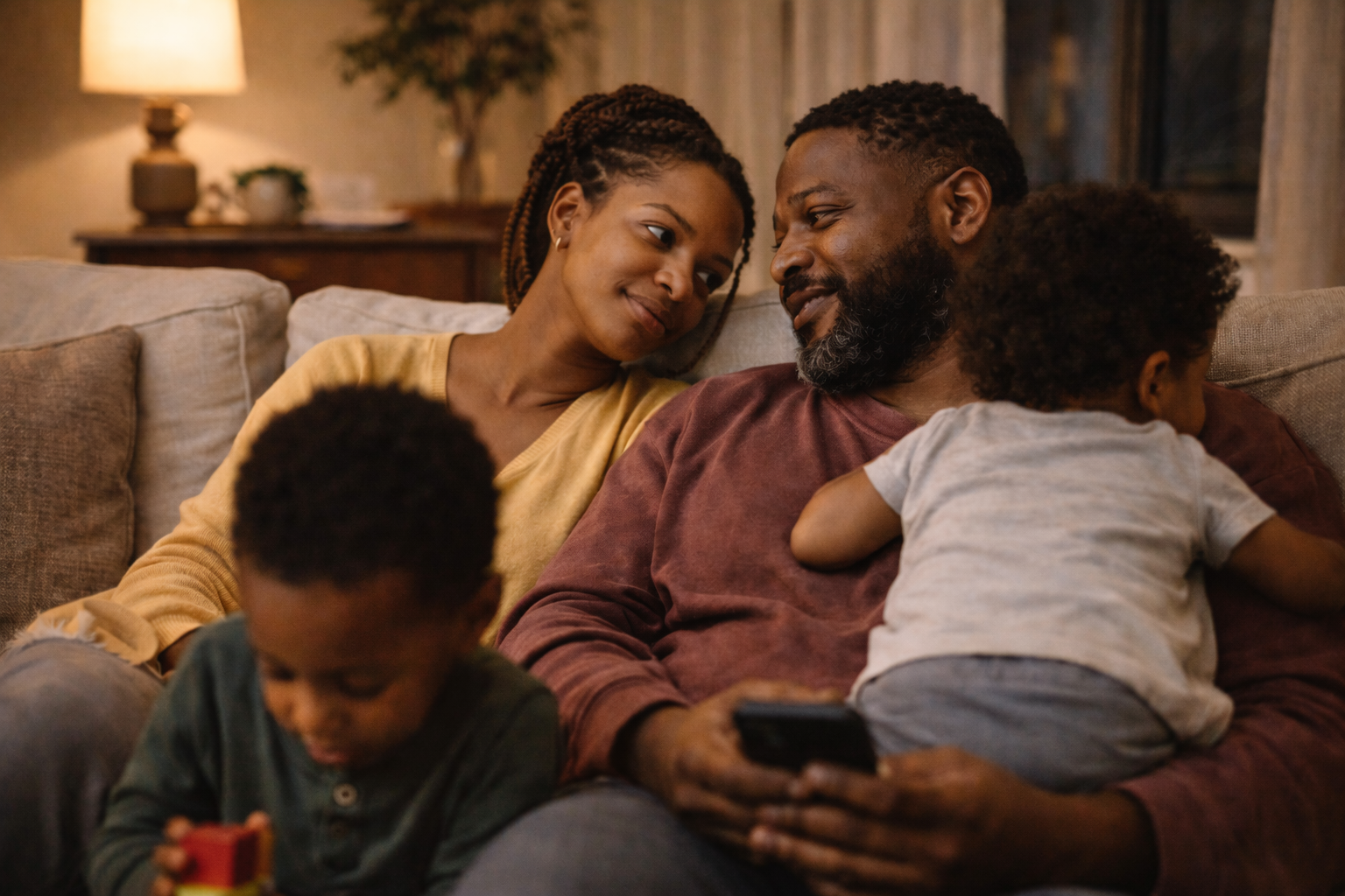 Atlanta couple making eye contact over their young children on a cozy evening